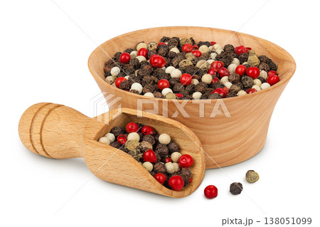 Pepper mix in a wooden bowl and spoon isolated on white background. Pepper mix in a wooden bowl and spoon isolated on white background. 138051099