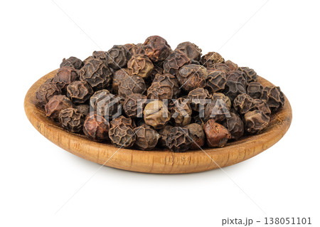 Black peppercorns or pepper in a wooden bowl isolated on a white background Black peppercorns or pepper in a wooden bowl isolated on a white background 138051101