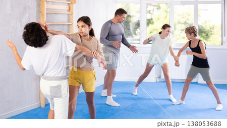 Boy and girl practicing self-defense techniques 138053688