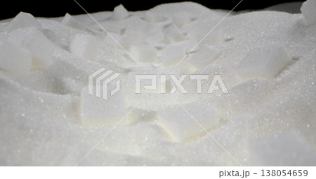 White sugar cubes scattered on fine sugar surface in a simple kitchen setup during daytime White sugar cubes scattered on fine sugar surface in a simple kitchen setup during daytime 138054659