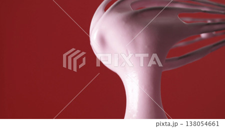 Whipping pink cream with a whisk in a kitchen on a bright red background during the day 138054661
