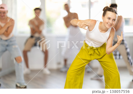 Teenage girl dancing hip hop in group 138057556