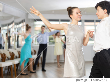 Enthusiastic teenagers performing waltz during group dance lesson 138057565