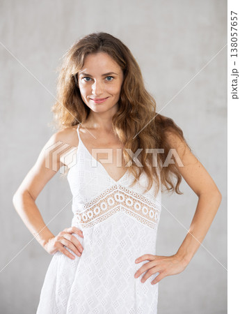 Young smiling woman posing against wall background 138057657