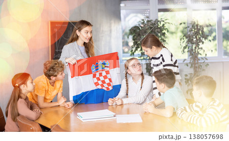 Teacher showing Croatia flag to group of schoolchildren 138057698