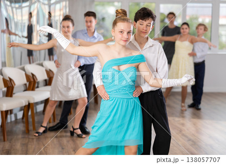 Teenage students rehearsing ballroom dance while preparing for college festive event Teenage students rehearsing ballroom dance while preparing for college festive event 138057707