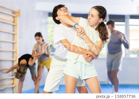 Boy and girl practicing self-defense techniques 138057736
