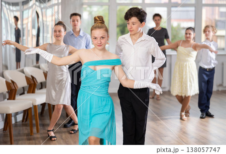 Boy and girl dancing ballroom dance in studio Boy and girl dancing ballroom dance in studio 138057747