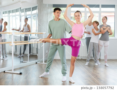 Boy and girl in pair train to perform ballet dance during rehearsal in studio Boy and girl in pair train to perform ballet dance during rehearsal in studio 138057792