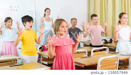 Schoolkids warming-up during lesson Schoolkids warming-up during lesson 138057846