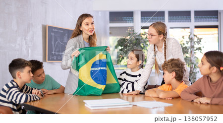 Teacher showing Brazil flag to group of schoolchildren Teacher showing Brazil flag to group of schoolchildren 138057952