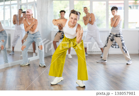 Teenage girl dancing hip hop in group 138057981