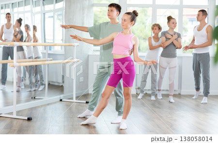 Ballet studio - teenagers girls and boys learn ballet movements in pairs Ballet studio - teenagers girls and boys learn ballet movements in pairs 138058014