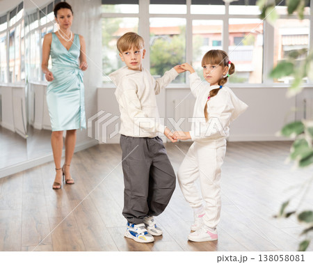 Boy and girl in sport wear train to dance contemporary vigorous rumba during classes. Boy and girl in sport wear train to dance contemporary vigorous rumba during classes. 138058081