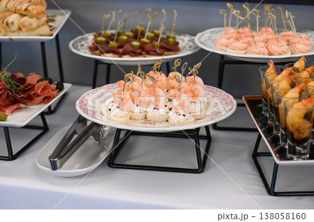 Assorted catering appetizer with shrimp canape and cream cheese on buffet table for event or party decoration with no people and copy space delicious Assorted catering appetizer with shrimp canape and cream cheese on buffet table for event or party decoration with no people and copy space delicious 138058160