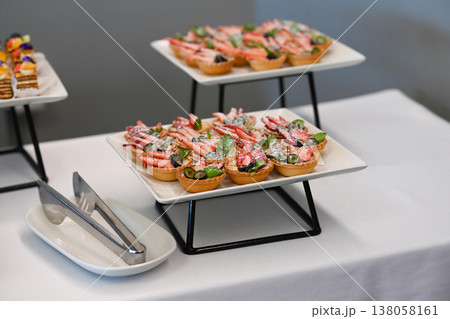 Assorted catering dessert with strawberry and blueberry fruit tart on buffet table for event or party decoration with no people and copy space sweet Assorted catering dessert with strawberry and blueberry fruit tart on buffet table for event or party decoration with no people and copy space sweet 138058161
