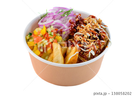 Chicken bowl with barbecue sauce potato wedge fresh vegetable salad and red onion in craft paper take out bowl on white background side view close up 138058202