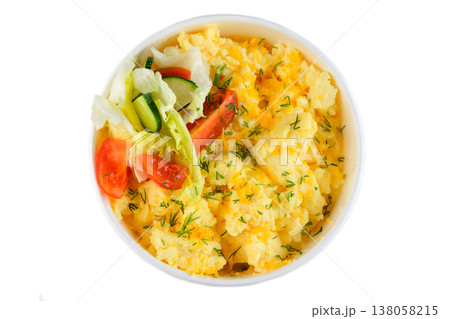 Fluffy scrambled egg with fresh tomato cucumber and lettuce salad in white paper take out bowl top view extreme close up flat lay breakfast 138058215