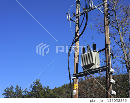 Utility pole transformer against clear blue sky Utility pole transformer against clear blue sky 138058826