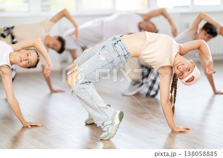 Teenage girl dancing breakdancing in group 138058885