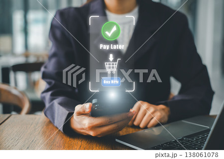 Businesswoman using smartphone for online shopping with pay later option in a modern office setting. Businesswoman using smartphone for online shopping with pay later option in a modern office setting. 138061078