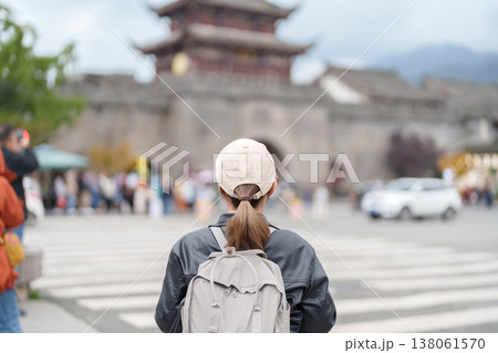 Happy woman traveler travel in Dujiangyan city. Tourist sightseeing Guanxian Ancient City near Chengdu. Landmark and popular for tourism attraction in Sichuan, China Happy woman traveler travel in Dujiangyan city. Tourist sightseeing Guanxian Ancient City near Chengdu. Landmark and popular for tourism attraction in Sichuan, China 138061570