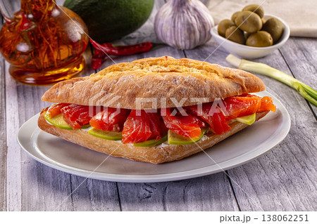 Gourmet smoked salmon sandwich with cream cheese and green apple on rustic ciabatta bread. Gourmet smoked salmon sandwich with cream cheese and green apple on rustic ciabatta bread. 138062251