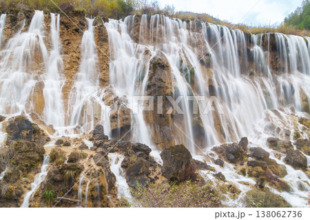 Scenery Jiuzhaigou national park in Sichuan, China. Beautiful of Nuorilang Waterfall in Autumn season. Famous Landmark and Vacation near Chengdu, China. Asia travel concept Scenery Jiuzhaigou national park in Sichuan, China. Beautiful of Nuorilang Waterfall in Autumn season. Famous Landmark and Vacation near Chengdu, China. Asia travel concept 138062736