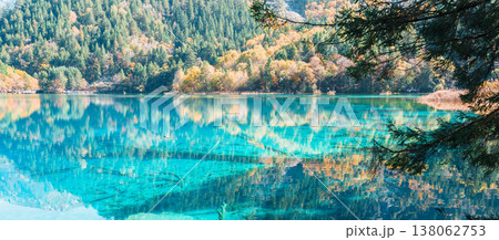 Scenery Jiuzhaigou national park in Sichuan, China. Beautiful Five Flower Lake in Autumn season. Famous Landmark and Vacation near Chengdu, China. Asia travel concept Scenery Jiuzhaigou national park in Sichuan, China. Beautiful Five Flower Lake in Autumn season. Famous Landmark and Vacation near Chengdu, China. Asia travel concept 138062753