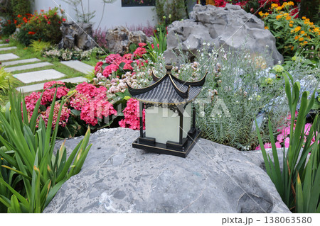 March 21 2026 Traditional Chinese Garden Lantern Among Blooming Flowers 138063580