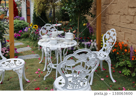 March 21 2026 Elegant white tea set on table in garden March 21 2026 Elegant white tea set on table in garden 138063600