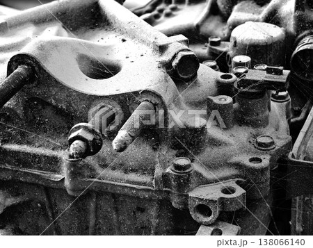 Rusted engine parts and corroded gears scattered across the sandy ground Rusted engine parts and corroded gears scattered across the sandy ground 138066140