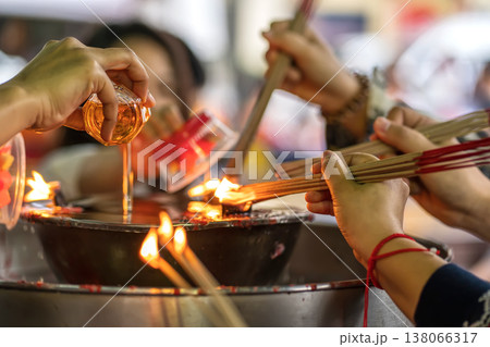 Pouring oil for shrine flame 138066317
