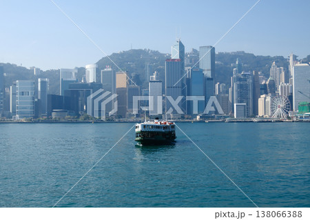 Iconic Star Ferry crossing Victoria Harbour with Hong Kong island skyline in background sunny day Iconic Star Ferry crossing Victoria Harbour with Hong Kong island skyline in background sunny day 138066388