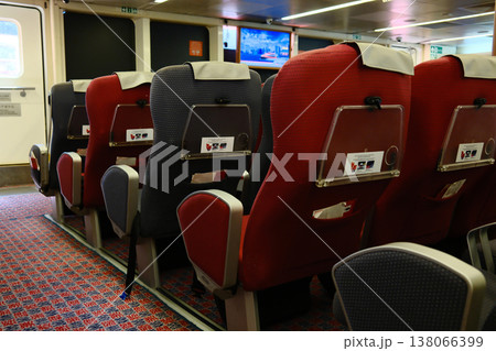 Red passenger seats interior of TurboJet high speed ferry cabin with TV screen Hong Kong Macau route Red passenger seats interior of TurboJet high speed ferry cabin with TV screen Hong Kong Macau route 138066399