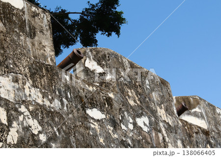 Weathered ancient stone fortress wall texture closeup with peeling surface in Macau historic fortification Weathered ancient stone fortress wall texture closeup with peeling surface in Macau historic fortification 138066405