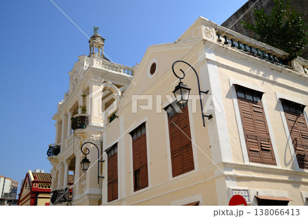 Classic Portuguese colonial white building with ornate lamp post and brown shutters in Macau historic district Classic Portuguese colonial white building with ornate lamp post and brown shutters in Macau historic district 138066413