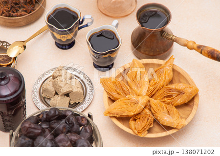 Ramadan Sweet Treats and Coffee Assortment on the table. Baklava, halva for dessert. Food and drink. Dates fruit Ramadan Sweet Treats and Coffee Assortment on the table. Baklava, halva for dessert. Food and drink. Dates fruit 138071202