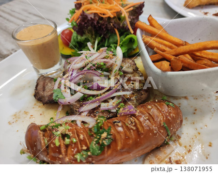 Meat Sausage Platter served with Fresh Garden Salad and Sweet Potato Fries on a Ceramic Platter Meat Sausage Platter served with Fresh Garden Salad and Sweet Potato Fries on a Ceramic Platter 138071955