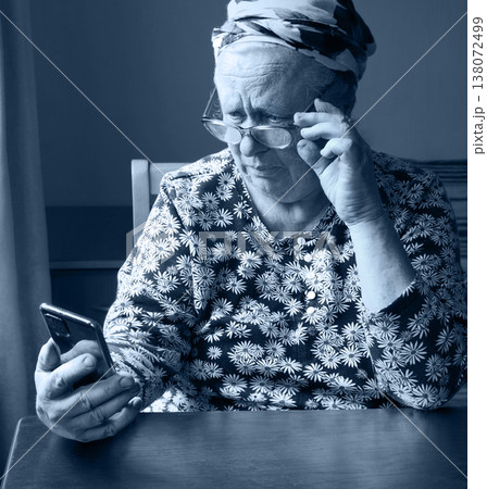 Old woman look at phone 138072499