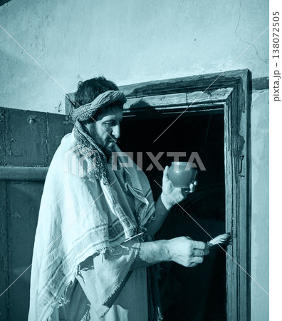 Man painting door with blood Man painting door with blood 138072505