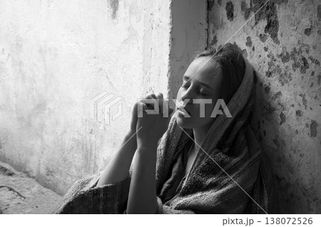 Poor young girl prayint to God 138072526