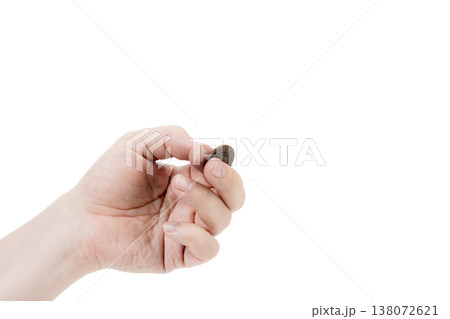 A man's hand is juggling a coin. 138072621
