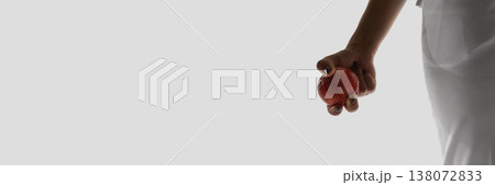 Female hand holding cricket ball minimal isolated banner on white background. 138072833