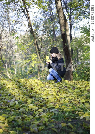 A young woman walks through the autumn park. A young woman walks through the autumn park. 138072895