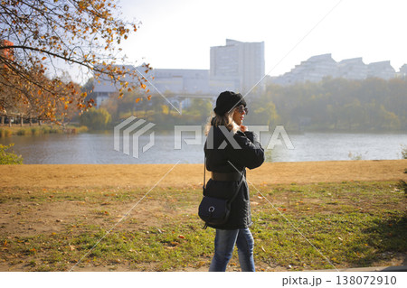 A young woman walks through the autumn park. A young woman walks through the autumn park. 138072910