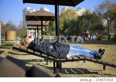 A young woman walks through the autumn park. A young woman walks through the autumn park. 138072928