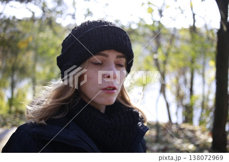 A young woman walks through the autumn park. A young woman walks through the autumn park. 138072969