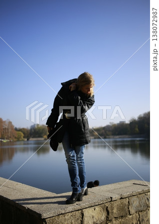 A young woman walks through the autumn park. A young woman walks through the autumn park. 138072987