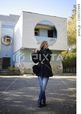 A young woman walks through the autumn park. 138072989